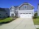Charming two-story home with grey siding, a two-car garage, and concrete driveway at 1141 Overlake Dr, Belmont, NC 28012