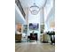 High ceiling living room with fireplace, built-in shelves, large windows, and a modern chandelier at 1141 Overlake Dr, Belmont, NC 28012