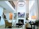 Elegant living room with fireplace, built-in shelves, large windows, and a modern chandelier at 1141 Overlake Dr, Belmont, NC 28012