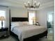 This bedroom features a modern chandelier and a large bed, offering a luxurious and comfortable space at 1141 Overlake Dr, Belmont, NC 28012