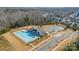 Aerial view of community pool, parking, and wooded area of this community at 1141 Overlake Dr, Belmont, NC 28012
