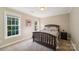 Bright bedroom with natural light, a decorative bed frame, and neutral-colored walls at 1237 Saint Johns Ave, Matthews, NC 28104