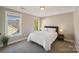 Simple bedroom with a light-colored carpet, neutral walls, and bright, natural light at 1237 Saint Johns Ave, Matthews, NC 28104