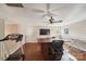 Spacious bonus room with hardwood floors, a ceiling fan, and a door; treadmill on the left at 1237 Saint Johns Ave, Matthews, NC 28104