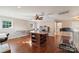 Large bonus room featuring hardwood floors, a ceiling fan, an ironing board, and a treadmill at 1237 Saint Johns Ave, Matthews, NC 28104