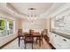Elegant dining room featuring a tray ceiling, wainscoting, and a built-in china cabinet at 1237 Saint Johns Ave, Matthews, NC 28104