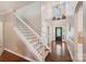Bright foyer with tall ceilings, dark hardwood floors, and a staircase with white wooden banisters at 1237 Saint Johns Ave, Matthews, NC 28104