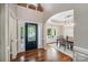 Inviting foyer with decorative glass front door and hardwood floors leading to dining room at 1237 Saint Johns Ave, Matthews, NC 28104