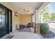 Charming covered front porch with a ceiling fan, sitting area, and a decorative front door at 1237 Saint Johns Ave, Matthews, NC 28104