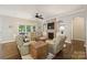 Cozy living room with a fireplace, built-in shelving, and comfortable seating with large windows at 1237 Saint Johns Ave, Matthews, NC 28104