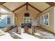 Covered patio with stone flooring, outdoor lighting, ceiling fan, and outdoor seating at 1237 Saint Johns Ave, Matthews, NC 28104