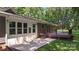 Backyard elevation showcasing the deck, doors, and windows overlooking a large flat green backyard at 1556 Stanley Lucia Rd, Mount Holly, NC 28120