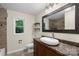 Bathroom features decorative mirror, window, granite counters with vessel sink and a tiled shower at 1556 Stanley Lucia Rd, Mount Holly, NC 28120