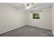 Bedroom with carpet has ceiling fan and window overlooking green trees and neutral paint at 1556 Stanley Lucia Rd, Mount Holly, NC 28120