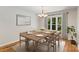 A dining room boasts a table with seating for eight, bathed in natural light from a nearby window at 1556 Stanley Lucia Rd, Mount Holly, NC 28120