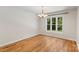 An airy dining room featuring hardwood floors and a large window with scenic views at 1556 Stanley Lucia Rd, Mount Holly, NC 28120
