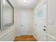 Bright foyer with a white door, trim, a mirror, and wood flooring offering a clean and inviting entrance at 1556 Stanley Lucia Rd, Mount Holly, NC 28120