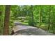 Exterior view of the home with a long driveway lined with mature trees at 1556 Stanley Lucia Rd, Mount Holly, NC 28120