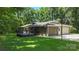 Rear exterior view of home with the deck, and large backyard featuring lush green trees at 1556 Stanley Lucia Rd, Mount Holly, NC 28120