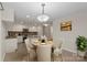 Eat-in kitchen featuring an island, granite countertops, stainless steel appliances, and a view of the eating area at 1556 Stanley Lucia Rd, Mount Holly, NC 28120