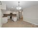 Bright eat-in kitchen with a central island, granite countertops, stainless steel appliances, and tile flooring at 1556 Stanley Lucia Rd, Mount Holly, NC 28120