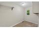 A simple laundry room offers practicality and a small window for natural light at 1556 Stanley Lucia Rd, Mount Holly, NC 28120