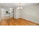 Bright living room and kitchen with hardwood floors and a view of the white-cabinet kitchen at 1556 Stanley Lucia Rd, Mount Holly, NC 28120