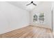 Inviting bedroom with vaulted ceiling, decorative wall, hardwood floors, and ample natural light from large windows at 177 Georgia Sw St, Concord, NC 28025