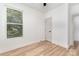Bright bedroom featuring wood floors, neutral walls, single window and a door at 177 Georgia Sw St, Concord, NC 28025