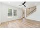 Bright living area with hardwood floors, large windows, and a modern staircase with a wood slat railing at 177 Georgia Sw St, Concord, NC 28025