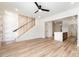 Open-concept living space showcasing hardwood floors, a staircase, and a view of the modern kitchen at 177 Georgia Sw St, Concord, NC 28025