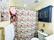 This bathroom showcases a decorative shower curtain, dark wall cabinet, and wall art at 2174 Eastview Rd, Rock Hill, SC 29732