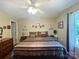 Spacious bedroom with hardwood floors features a king bed, ample natural light, and neutral paint colors at 2174 Eastview Rd, Rock Hill, SC 29732