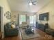 Open living room featuring a ceiling fan, hardwood floors, and access to the front entrance at 2174 Eastview Rd, Rock Hill, SC 29732