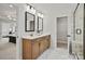 Bathroom with double sinks, wood cabinets, white countertop, and a walk-in closet at 2192 Millennium Dr # 91, Lancaster, SC 29720