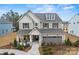 Stunning two-story home with a welcoming front porch, stone accents, manicured landscaping, and a two-car garage at 2192 Millennium Dr # 91, Lancaster, SC 29720