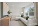 Bright sitting area features a white sofa, modern lighting, and natural light at 2192 Millennium Dr # 91, Lancaster, SC 29720