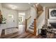Inviting entryway with wood floors, white door, and staircase with wood railing at 2198 Millennium Dr # 90, Lancaster, SC 29720