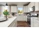 Bright kitchen featuring white cabinets, quartz countertops, and stainless steel appliances at 2198 Millennium Dr # 90, Lancaster, SC 29720