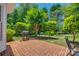 Serene backyard with mature trees and a brick patio featuring a grill at 2289 Veery Ln, Rock Hill, SC 29732