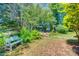 Picturesque backyard oasis with stone pathway, bench, and secluded gazebo at 2289 Veery Ln, Rock Hill, SC 29732