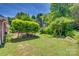 Beautifully manicured backyard featuring mature trees and lush green lawn for outdoor enjoyment at 2289 Veery Ln, Rock Hill, SC 29732