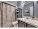 Cozy bathroom with tiled shower, decorative shelves, and traditional vanity at 2289 Veery Ln, Rock Hill, SC 29732