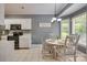 Bright dining area features white cabinets, a modern chandelier, and natural light from multiple windows at 2289 Veery Ln, Rock Hill, SC 29732