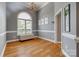 Elegant dining room with hardwood floors, arched window, chandelier, and neutral wall color at 2289 Veery Ln, Rock Hill, SC 29732