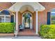 Inviting brick front porch featuring a cozy seating area and decorative plants at 2289 Veery Ln, Rock Hill, SC 29732