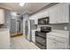 Spacious kitchen boasts white cabinets, stainless steel refrigerator, and modern black appliances at 2289 Veery Ln, Rock Hill, SC 29732