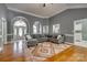 Open-concept living room featuring hardwood floors, comfortable seating, and elegant archways leading to the foyer at 2289 Veery Ln, Rock Hill, SC 29732