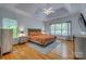 Spacious main bedroom features a tray ceiling, ceiling fan, hardwood floors, and natural light at 2289 Veery Ln, Rock Hill, SC 29732