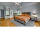 Bright main bedroom features hardwood floors, a ceiling fan, and natural light from multiple windows at 2289 Veery Ln, Rock Hill, SC 29732